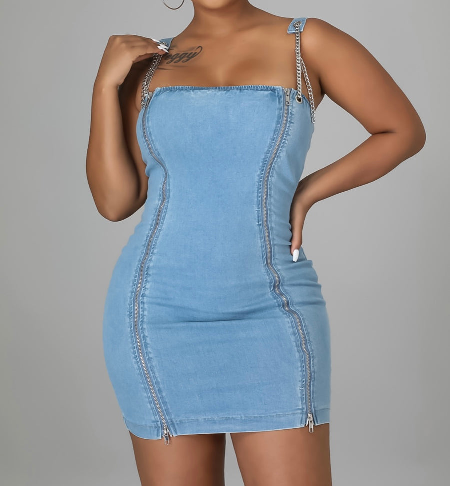 Our women lost in translation is a beautiful stretchy denim fabric accessories with silver chains along the straps and zippers to the front style this dress for the perfect late spring summer looks get those barbecue steers and flares as you step in you heels, wedge or flats Size Small, Medium, Large 